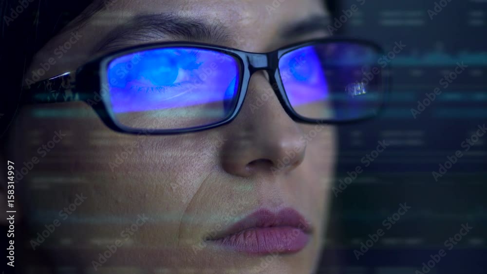 The serious businesswoman with a glasses look to the virtual screen