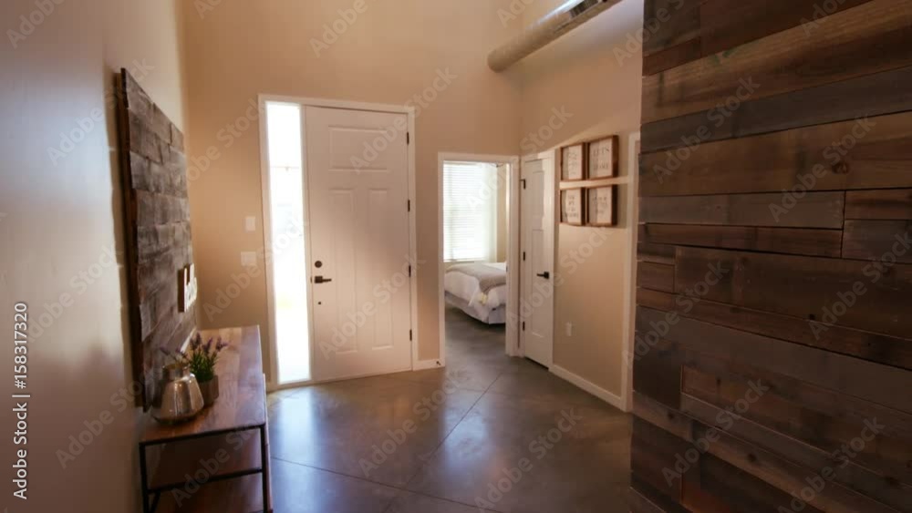 Rising Home Entrance Hallway with Wood Wall. view looking at the front door of a home entrance way and hallway
Rising Home Entrance Hallway with Wood Wall. view looking at the front door of a home entrance way and hallway