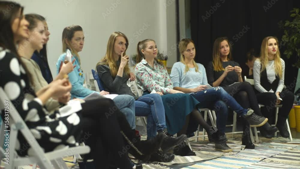 Women are sitting in the circle during meeting