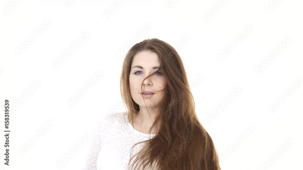 Woman with hair tied in ponytail loosing her long smooth natural brown hairs. Haircare concept. Studio shot, isolated on white 4K ProRes HQ codec Woman with hair tied in ponytail loosing her long smooth natural brown hairs. Haircare concept. Studio shot, isolated on white 4K ProRes HQ codec