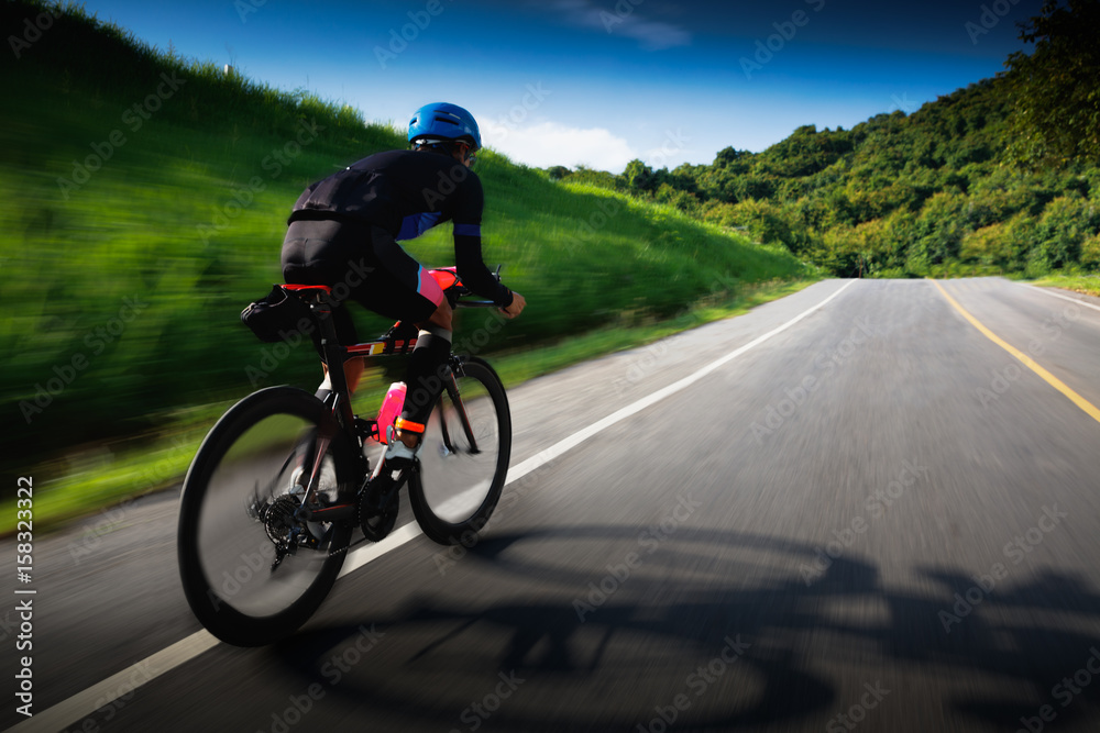 Motion blur of Cyclist in maximum effort in a road outdoors Motion blur of Cyclist in maximum effort in a road outdoors
