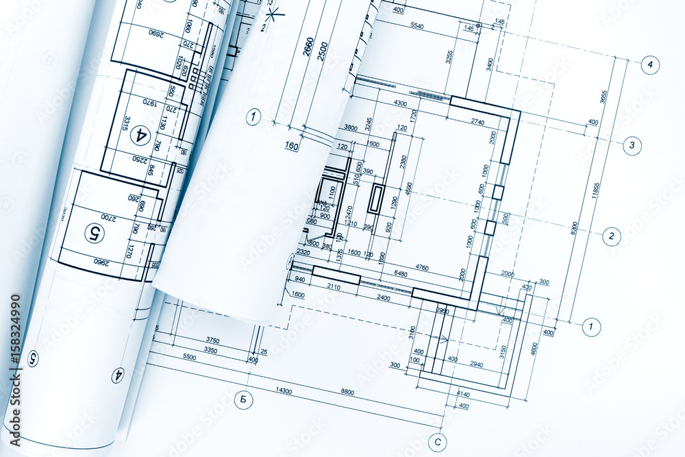 rolls of architectural blueprints and technical drawings on architect workplace rolls of architectural blueprints and technical drawings on architect workplace