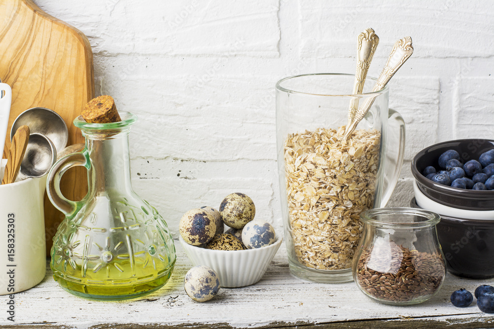 Kitchen tools, olive cutting board on a kitchen shelf against a white brick wall. selective focus Kitchen tools, olive cutting board on a kitchen shelf against a white brick wall. selective focus