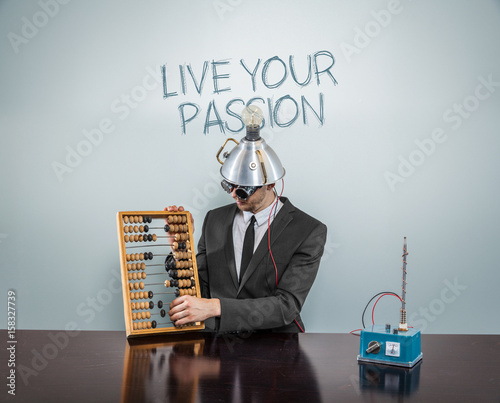 Fotografija Live your passion text on blackboard with businessman