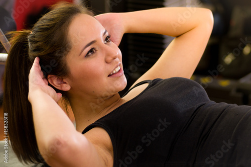 Beautiful woman doing abs in the gym photo