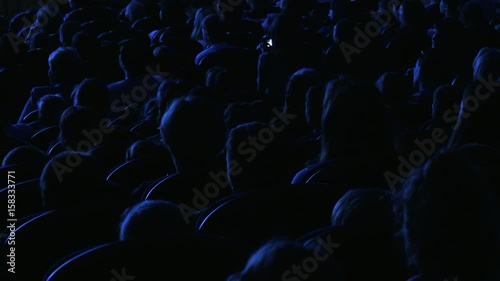 Spectators watch the show or view in the theater. Video from the back. Children and adults alike. Clip footage in 4K.