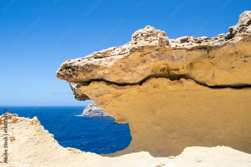 Pathway along rocky coastline at Gozo island in Malta.