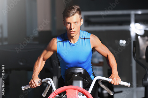 Athletic man training in modern gym