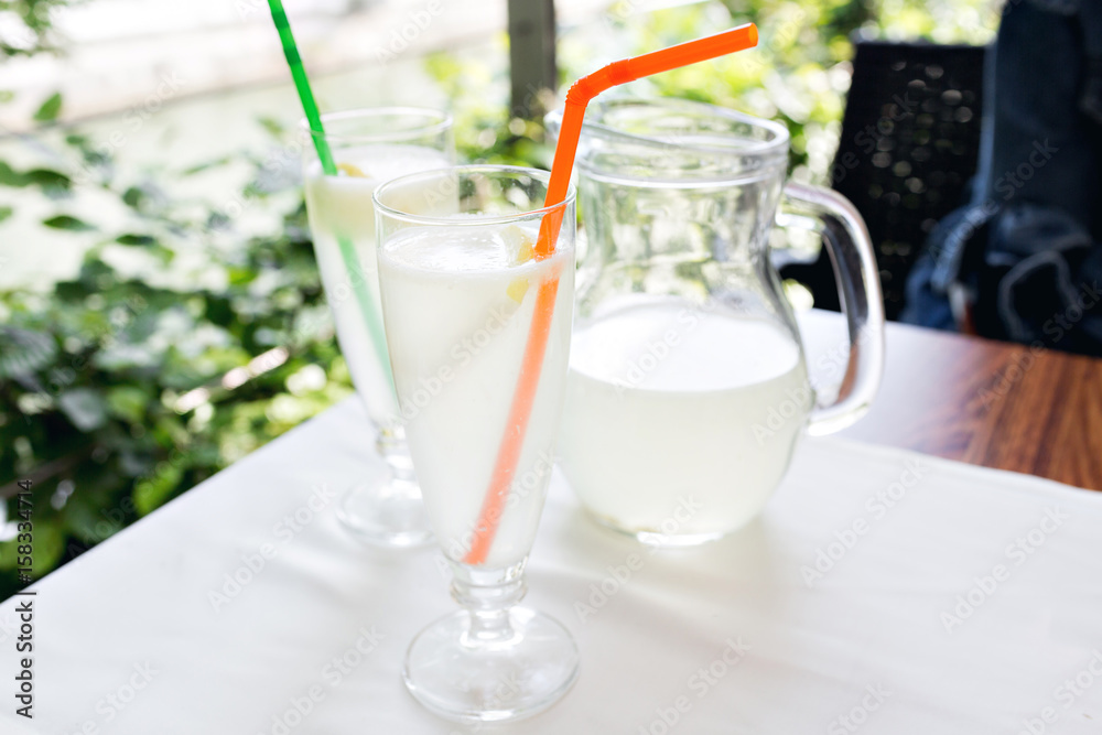 Lemonade, a refreshing drink in glass. City cafe, street background. Lemonade, a refreshing drink in glass. City cafe, street background.