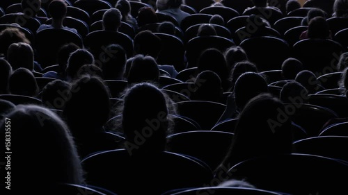 Spectators watch the show or view in the theater. Video from the back. Children and adults alike. Clip footage in 4K.