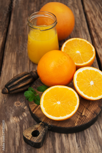 Jar of juice and fresh oranges