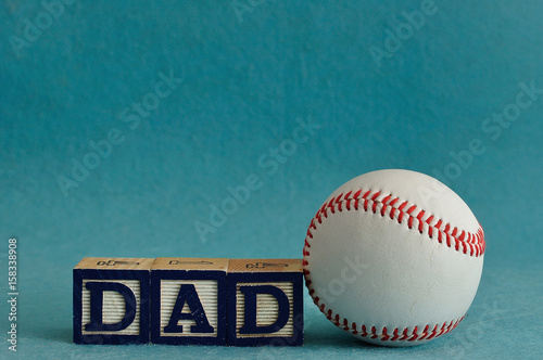 Dad spelled with colorful blocks with a baseball