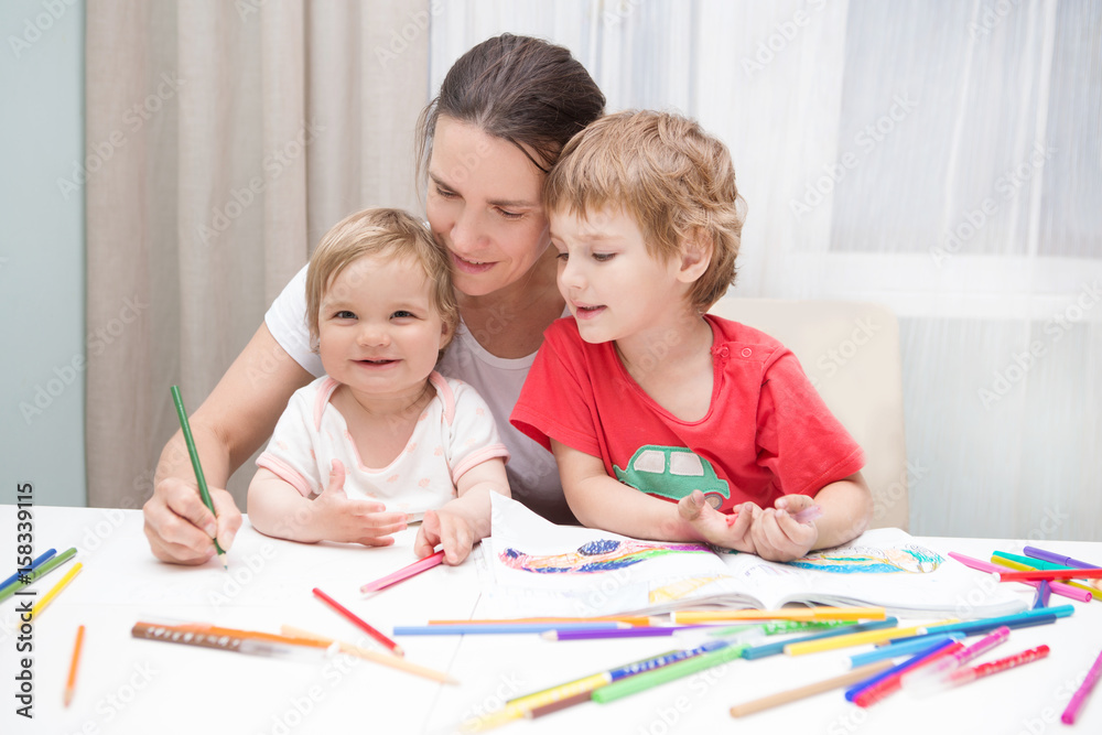 Happy family. mother draws with two small children together. Happy family. mother draws with two small children together.