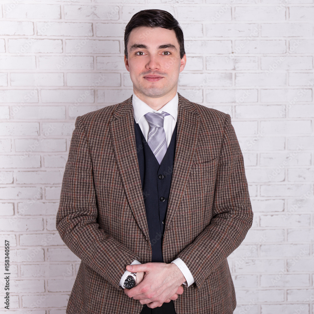 portrait of young handsome businessman posing over white wall portrait of young handsome businessman posing over white wall