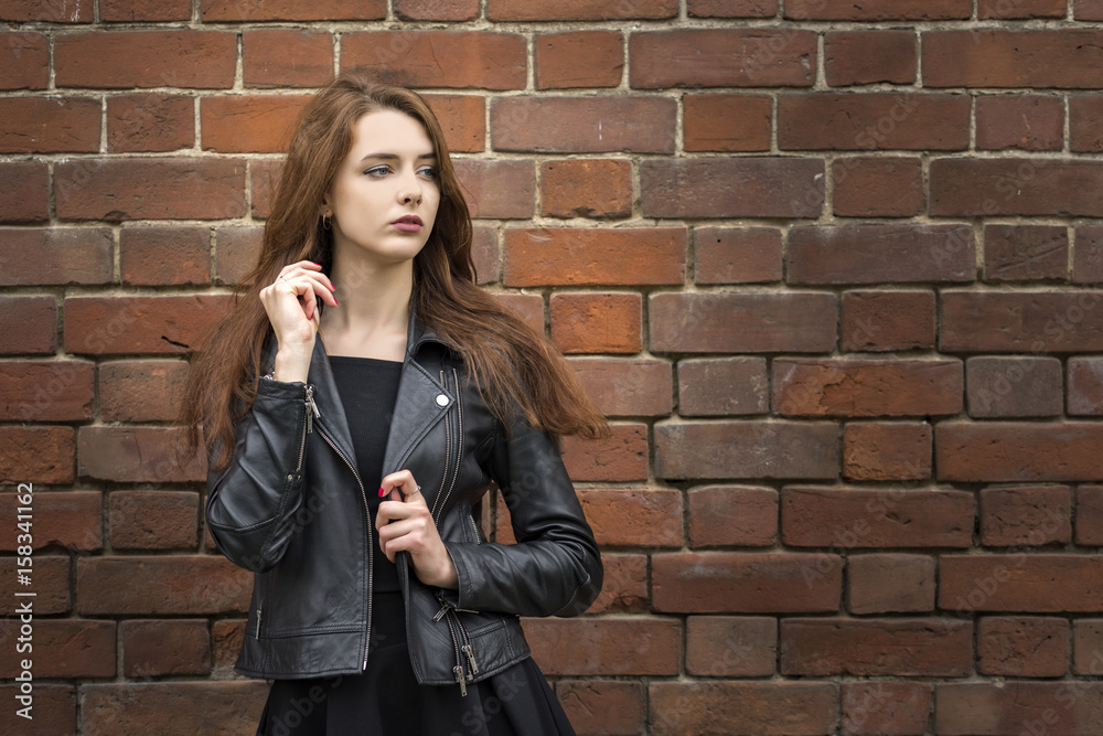 Girl with long hair near an old brick wall Girl with long hair near an old brick wall