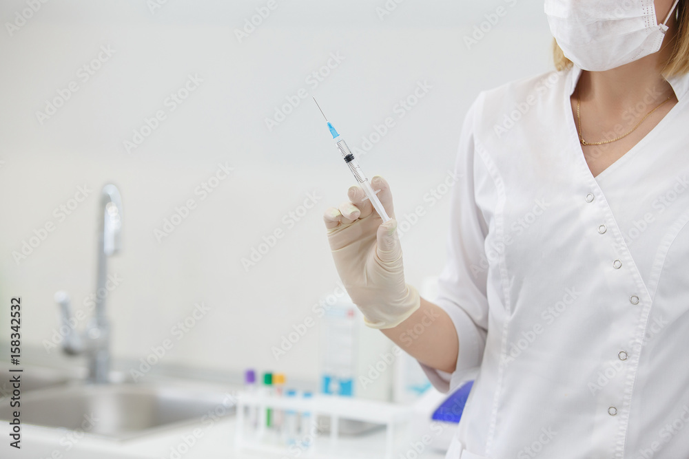 Hands of female doctor in gloves with syringe Hands of female doctor in gloves with syringe