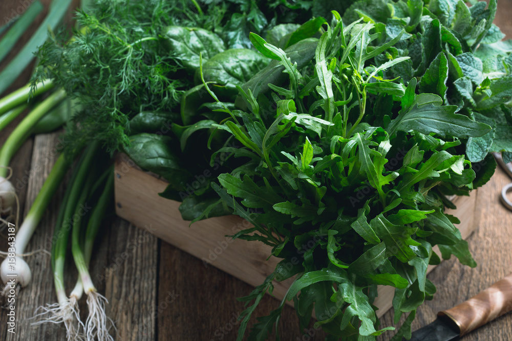 Organic fresh herbs in wooden crate