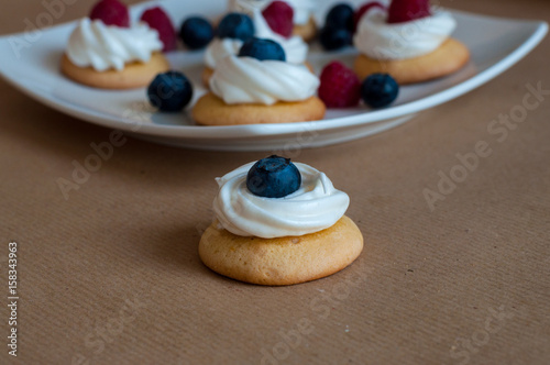 Waffle cookies with meringue and berries photo