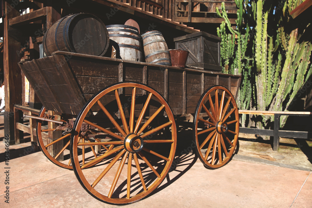 Old wooden cart with wine barrels.Wild West. Retro photo with historical transport