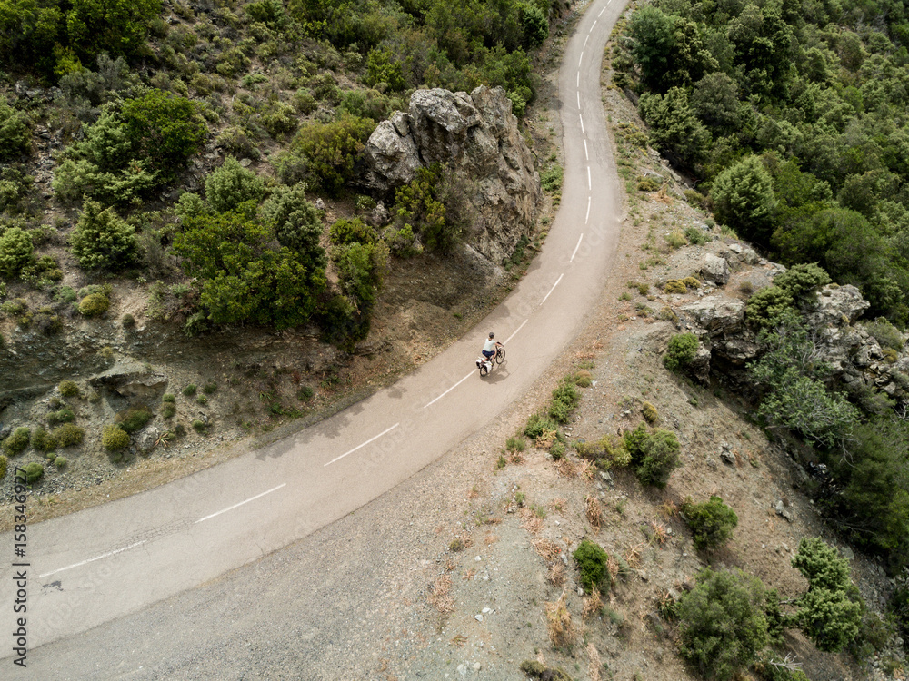 Aerial view of cyclist on a lonely small road