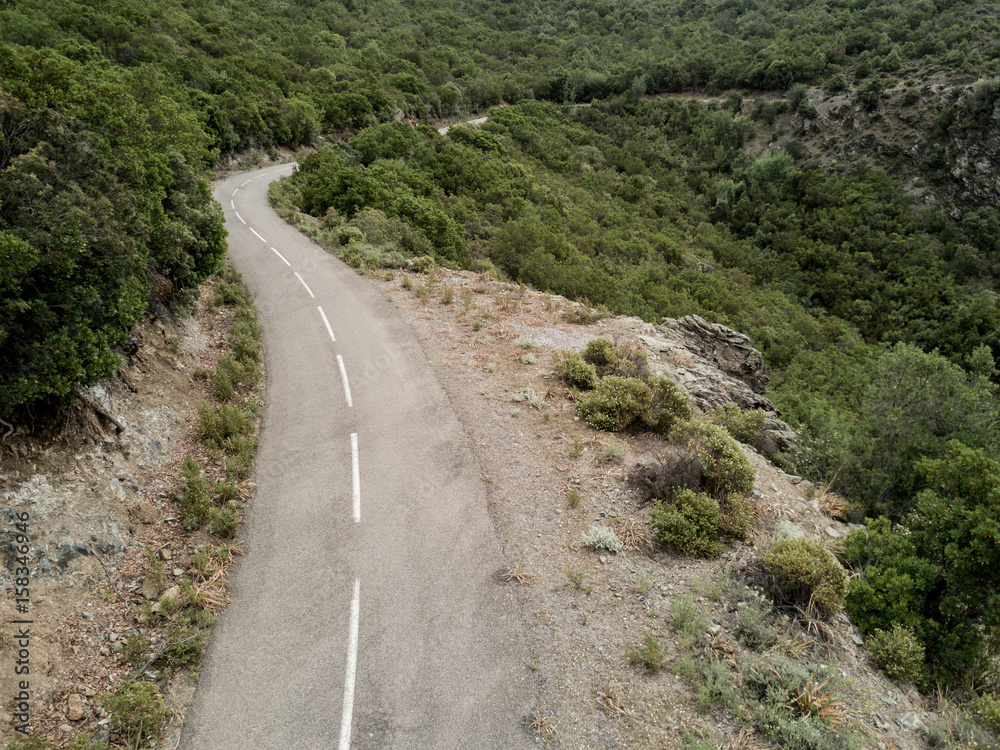 Aerial view of small curvy road in Corsica