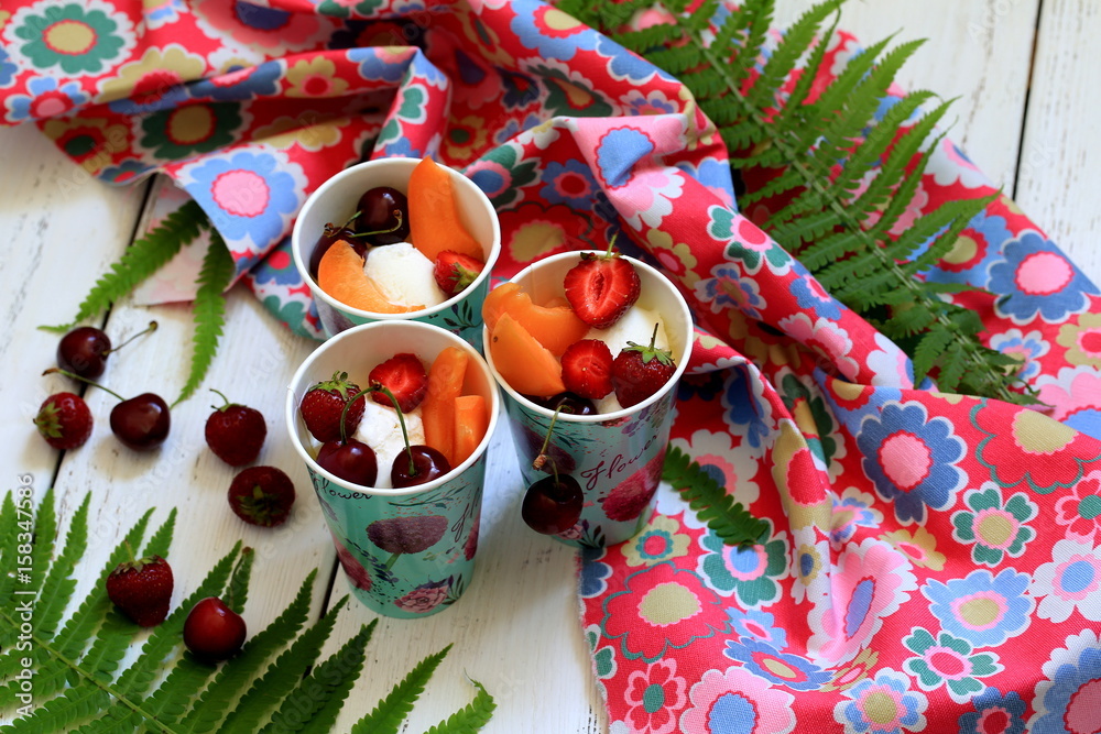 Vanilla ice cream with fruits in cups