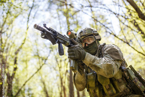 Soldier aiming holding submachine gun