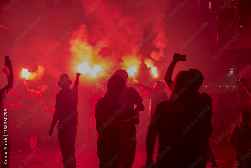 Obraz premium TURKEY - ISTANBUL 4 July 2017 : 2016-2017 turkish league champions Besiktas fans celebrating their championship . Fanatic group of their team CARSIs celebrating moments with flags and torchs