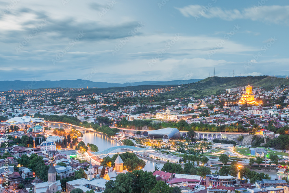 Fototapeta premium Capital of Georgia - Tbilisi at night against the dark blue sky.