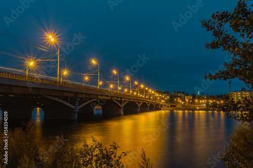 Chernavsky bridge in the evening, Voronezh, Russia. An HDR image of the bridge over river and Voronezh reservoir, taken in the night.The bridge and the streetlights on it form a diagonal of the image. photo