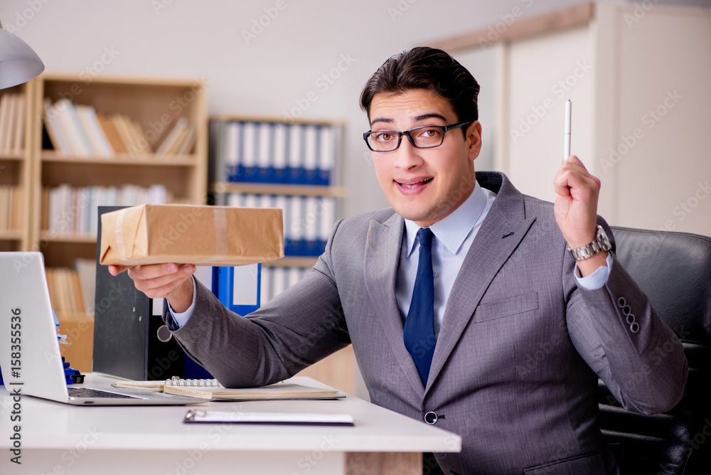 Businessman receiving parcel in office Businessman receiving parcel in office