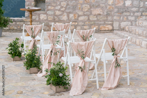 Fototapeta Naklejka Na Ścianę i Meble -  decorated chairs at the wedding venue