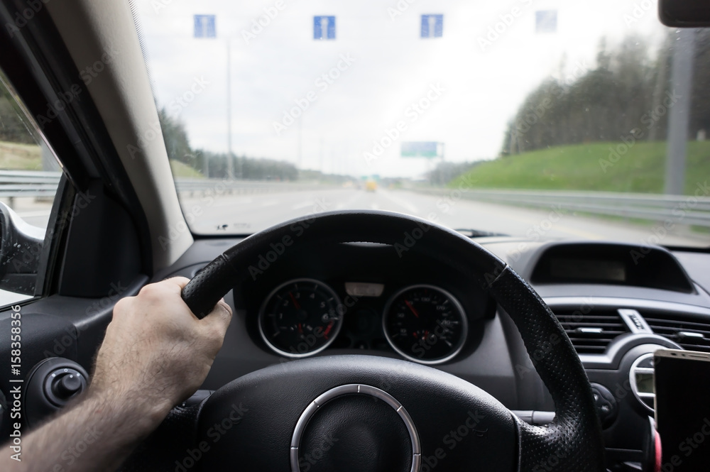 Close-up of hands on a steering wheel