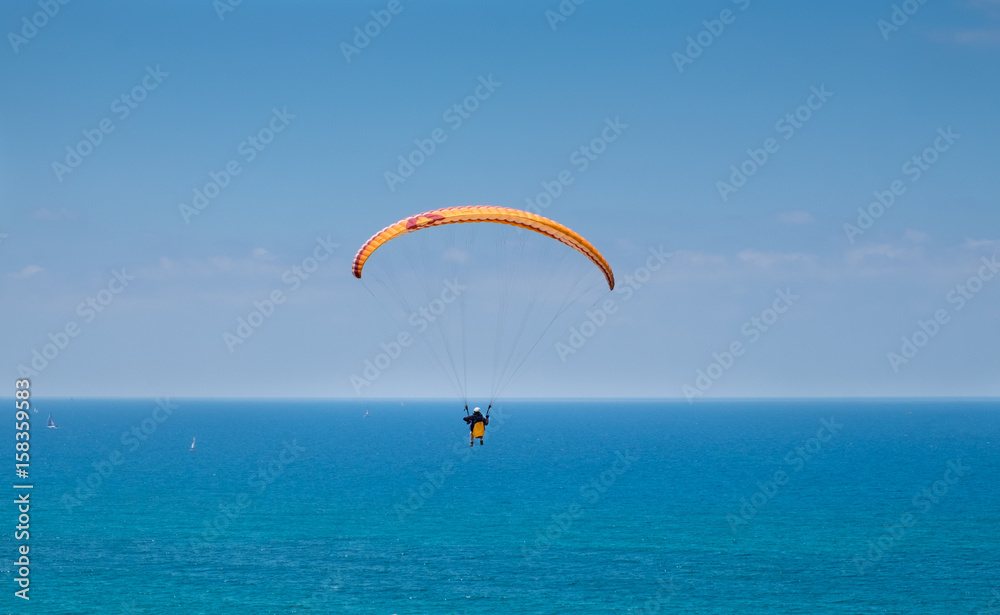Paragliding above Mediterranean sea on blue sky background Paragliding above Mediterranean sea on blue sky background
