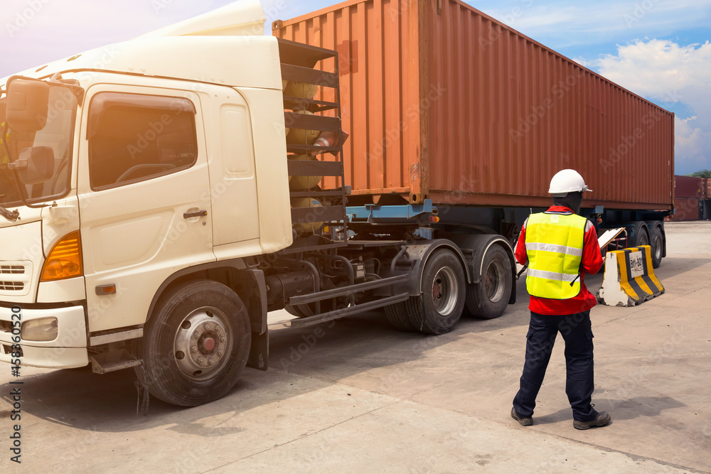 Fototapeta premium Foreman control loading Containers box to truck for Logistic Import Export Background, Business logistic concept