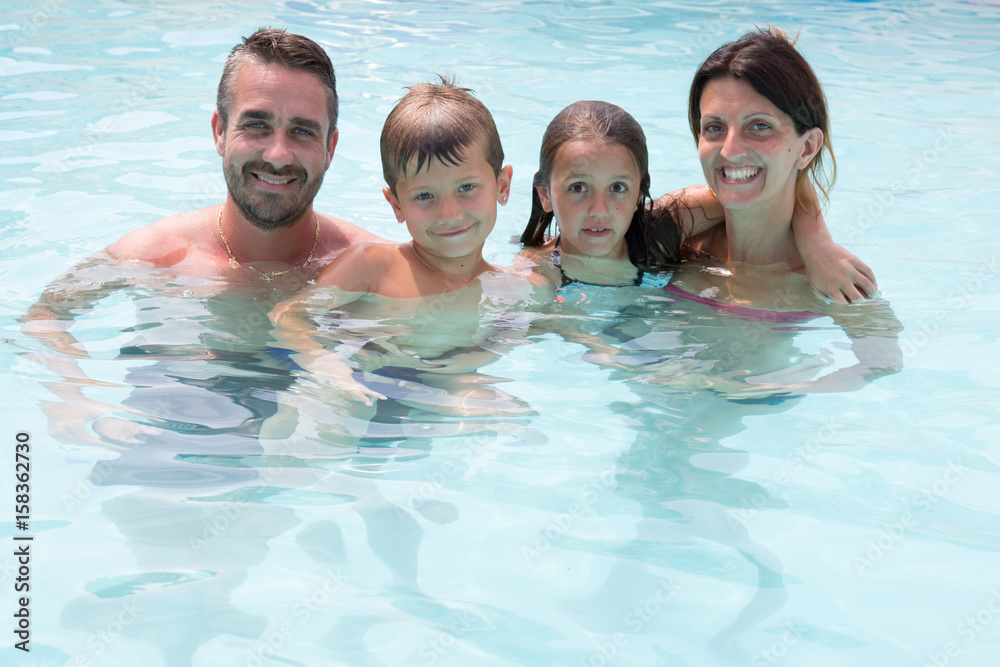 kids boy and girl in summer pool with parent kids boy and girl in summer pool with parent