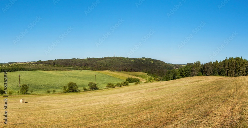 Panorama of a hilly forested landscape near the town of Tisnov in the Czech Republic. A sunny morning in the pasture. Panorama of a hilly forested landscape near the town of Tisnov in the Czech Republic. A sunny morning in the pasture.
