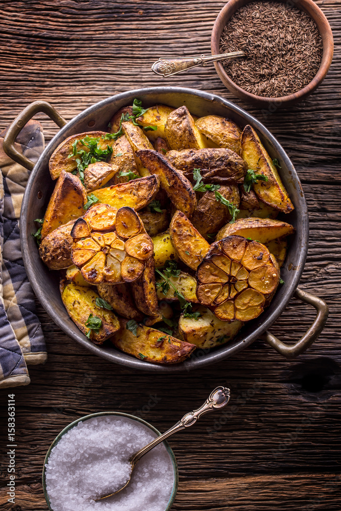 American potatoes. Baked potatoes in peel. Roasted potatoes with garlic spices salt cumin and herbs. American potatoes. Baked potatoes in peel. Roasted potatoes with garlic spices salt cumin and herbs.