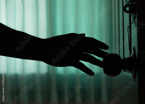 shadow man hand open the door. at night home.