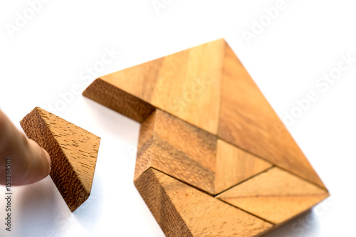 Wooden tangram puzzle in square shape wait for fulfill on white background