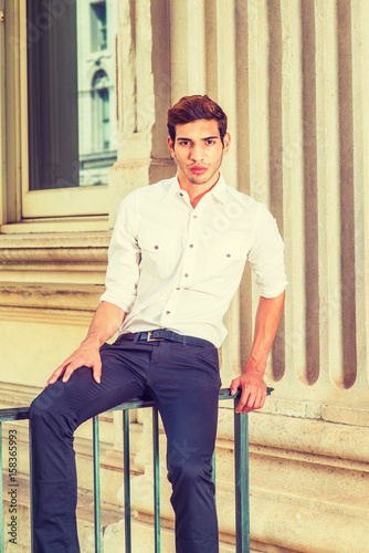 Young American Man sitting outside, thinking, relaxing.