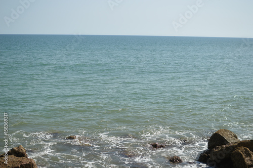 Sunny panoramic view of the ocean with rocks, seascape natural outdoors background © aquar