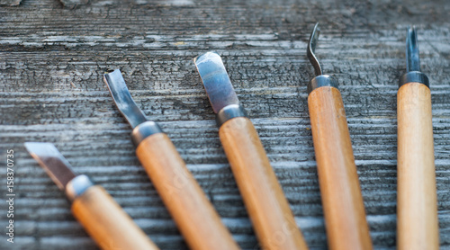 Tool for wood carving on an old wooden background