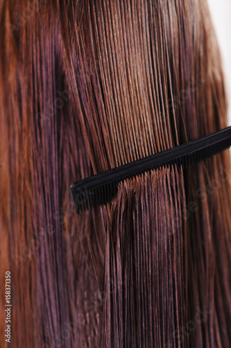 Female hairdresser comb and scissors closeup