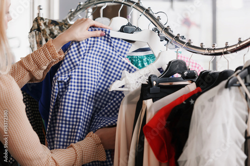 Clothing stylist chooses clothes in store