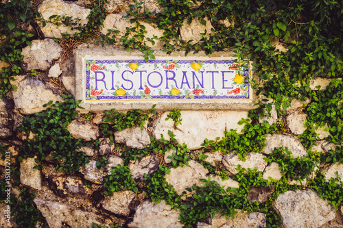Close up detail of the sign Ristorante on the stone wall in vintage style