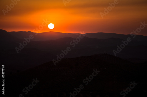 Panoramic and idyllic Andalusian landscape, mountain village Alcaudete at sunset