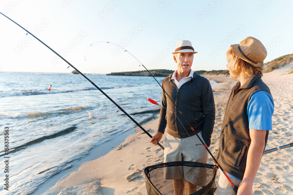 Senior man fishing with his grandson Senior man fishing with his grandson