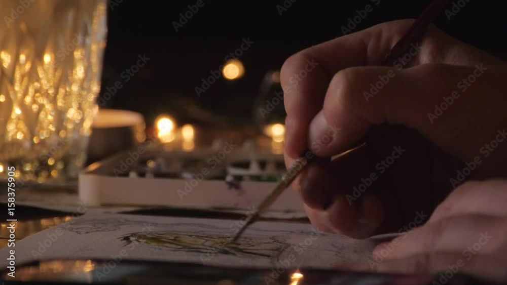 woman painter artist painting a picture of a fantasy cave with watercolour woman painter artist painting a picture of a fantasy cave with watercolour