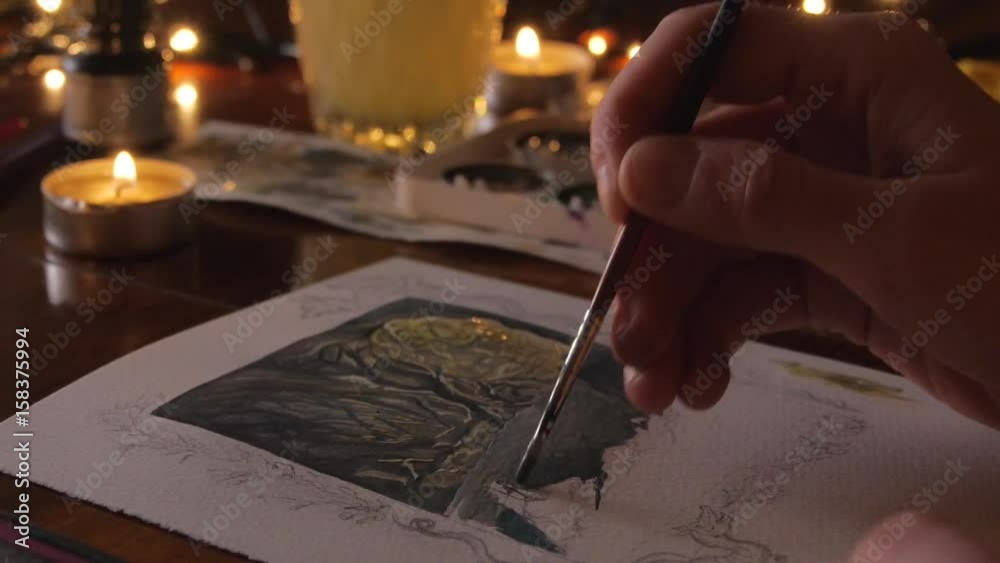 woman painter artist painting a picture of a fantasy cave with watercolour woman painter artist painting a picture of a fantasy cave with watercolour